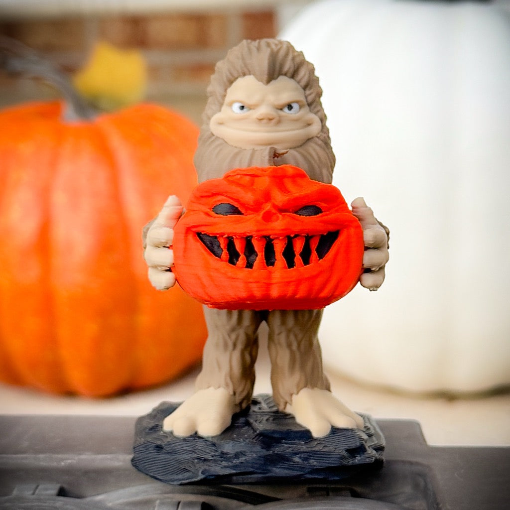 Pumpkin Patch Bigfoot by FirstWarrior features a smiling Bigfoot holding a jack-o’-lantern among pumpkins. This playful 3D-printed figurine makes a charming Halloween Jeep accessory or festive decor piece.