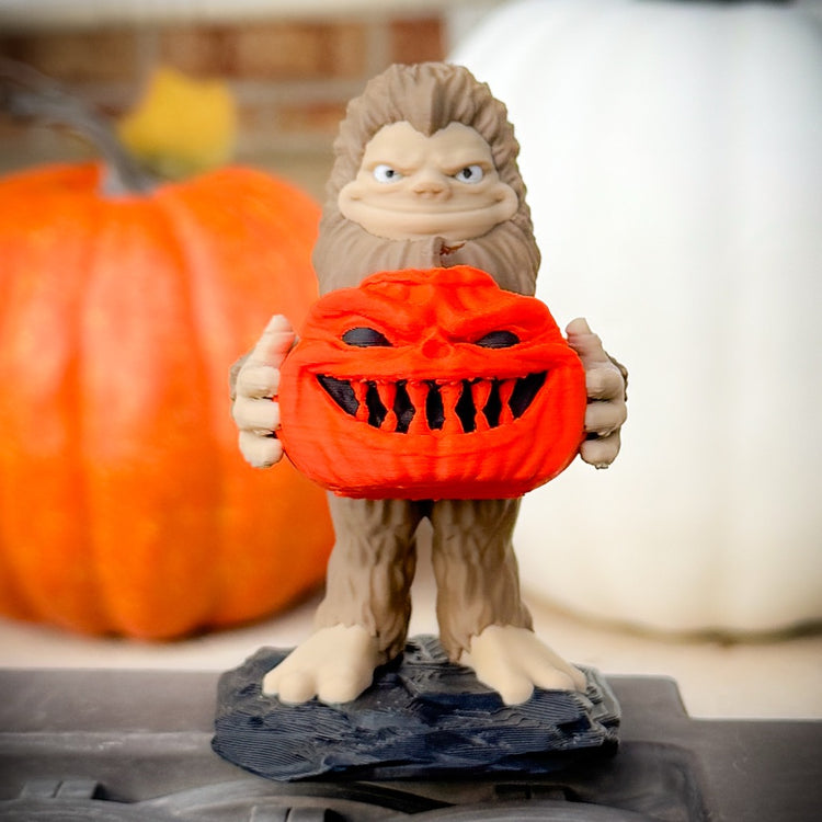 Pumpkin Patch Bigfoot by FirstWarrior features a smiling Bigfoot holding a jack-o’-lantern among pumpkins. This playful 3D-printed figurine makes a charming Halloween Jeep accessory or festive decor piece.