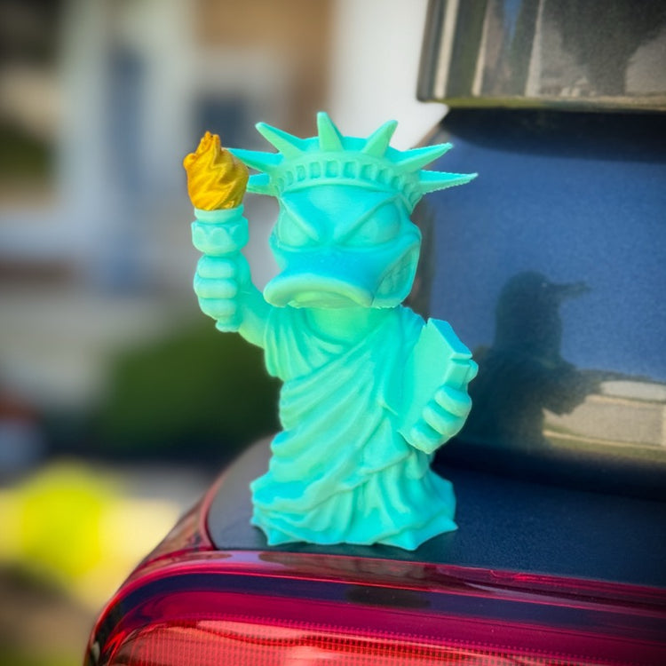 Colorful Statue of Liberty figurine on a car's tail light