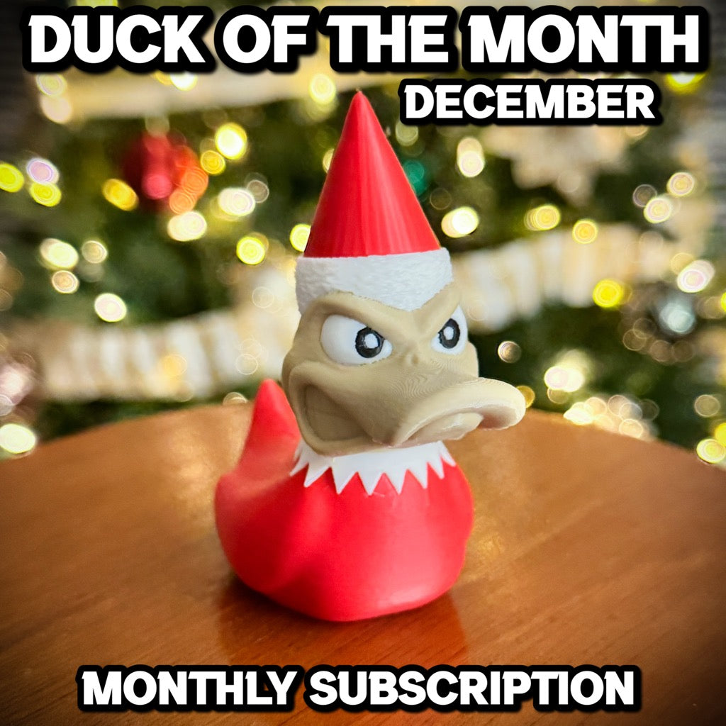 A festive rubber duck in a red Santa hat and coat sits on a table, with blurred Christmas lights behind. Text: Duck of the Month - December by F1rstWarrior—subscribe for your own holiday Duck on the Shelf!.